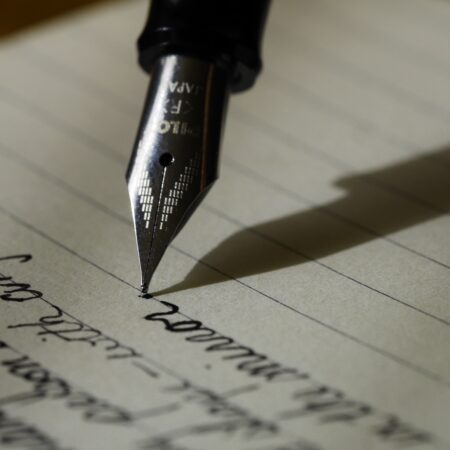Close up of fountain pen nib writing on paper.
