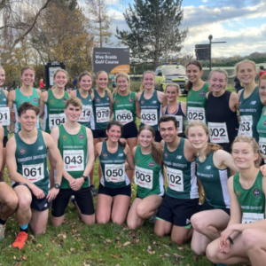 Large group photo of Libby with fellow running team members.