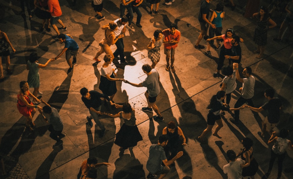 People ceilidh dancing in hall