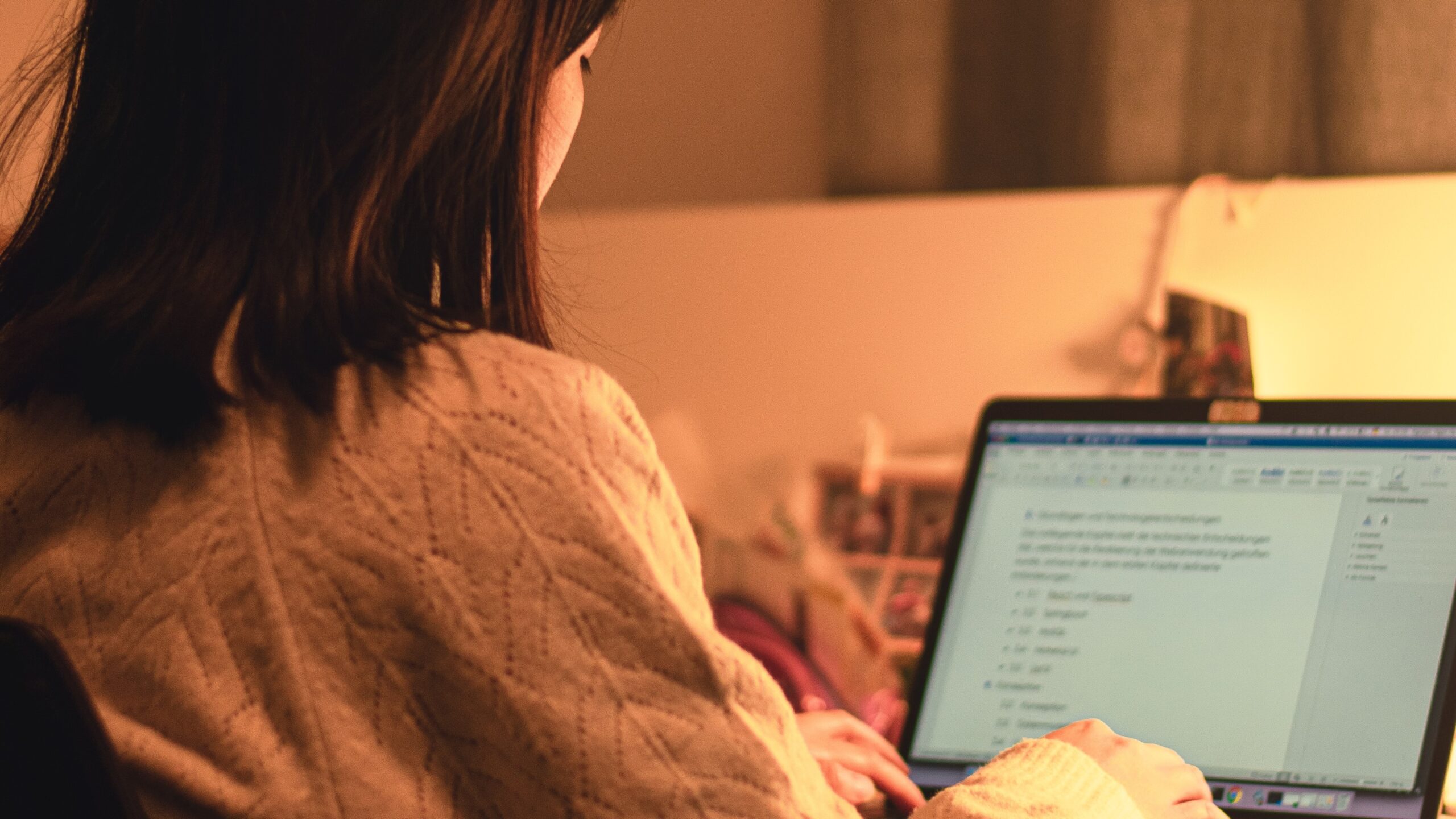 Woman writing using a laptop