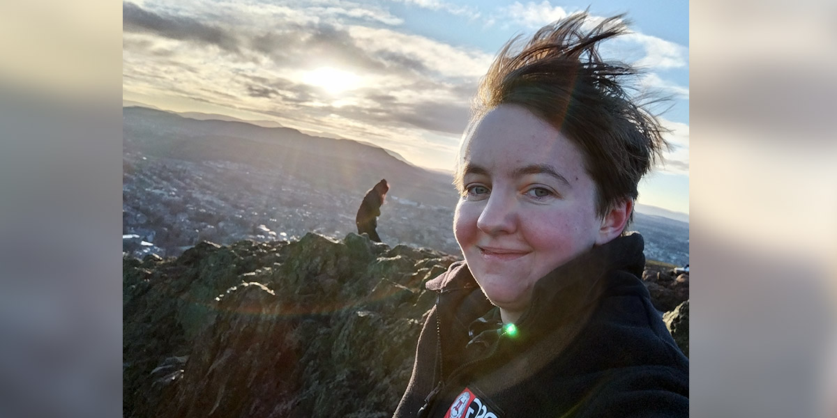 Natalia at the top of a hill on a windy day.