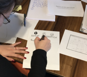 Person sketching a user interface on paper