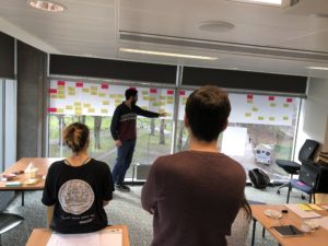 Student points at post it notes on wall